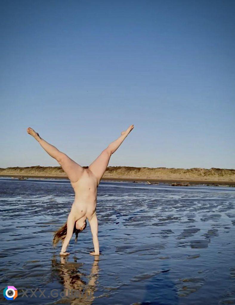 My wife, naked cartwheeling at the local beach