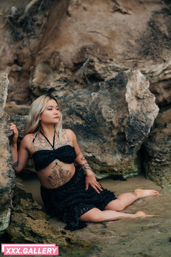 Tattooed siren at the beach chilling